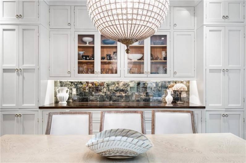 Glass doors, cabinet storage, chandelier over dining table.