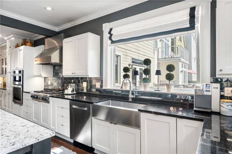 Large picture window over the aproned stainless sink.