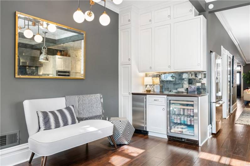 Breakfast nook/sitting area with added buffet, dry bar with ice maker and beverage fridge.