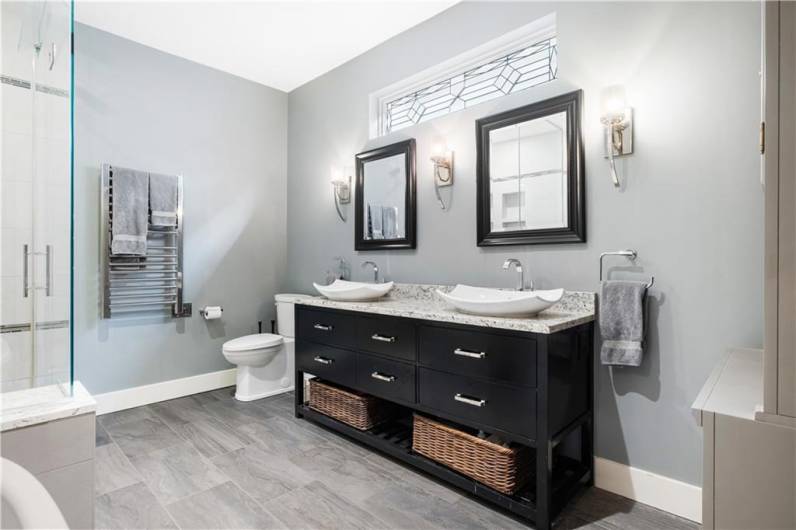 Luxurious primary bathroom with double sinks