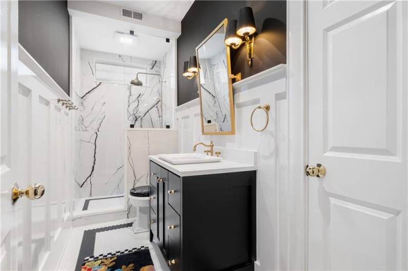 Renovated hall bathroom with penny tile.