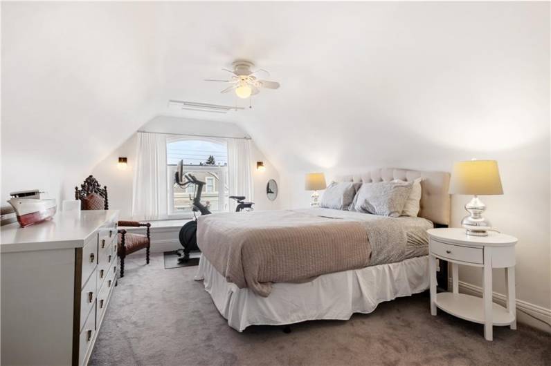 Bedroom on third floor with ceiling fan.