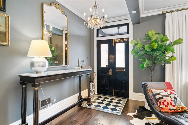 Light and bright front entry. Wide planked baseboards and crown molding through out the first floor.