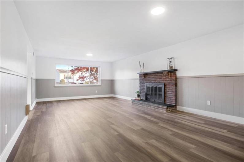 Beautiful Brick Wood burning Fireplace with Concrete Hearth and Mantle & Large Triple Window Set