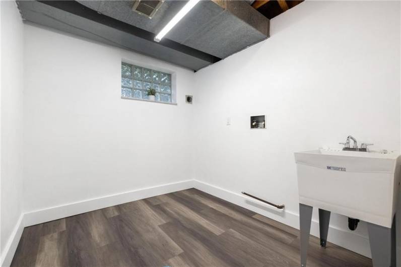 Spacious Laundry room with Utility Sink and Glass Block Window.