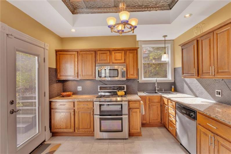Granite countertops, new appliances, tin ceiling, and a new Anderson patio door with built in blinds.