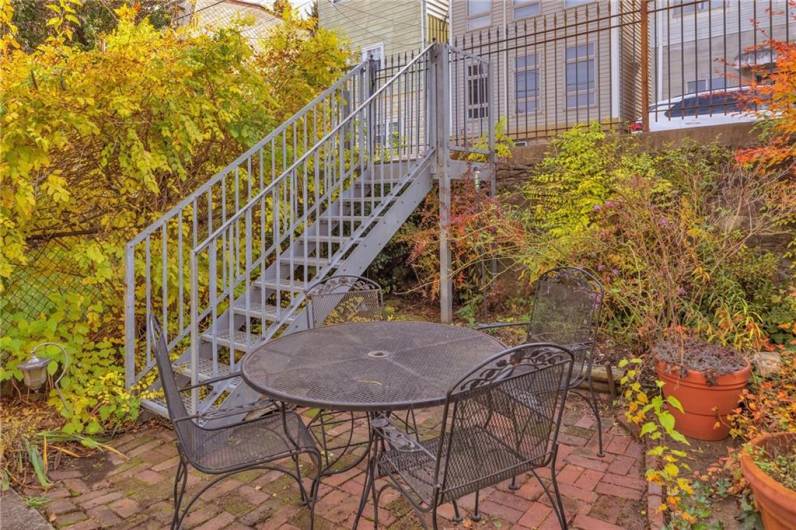 Reclaimed brick back patio, accessed from kitchen or dining room french doors. Custom steel staircase to access Gregory Street.