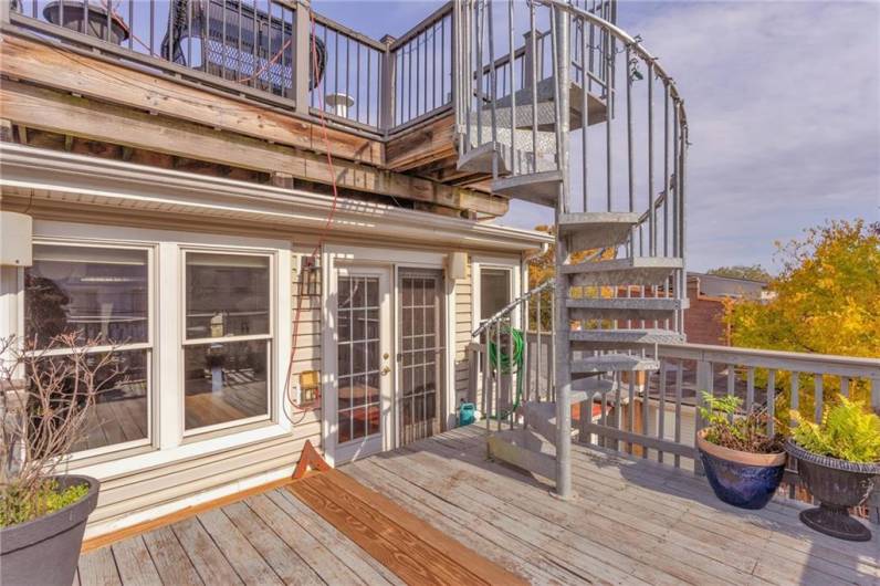 Custom staircase taking you to the top deck. Hose with spigot and outlets available for tending to your rooftop garden.