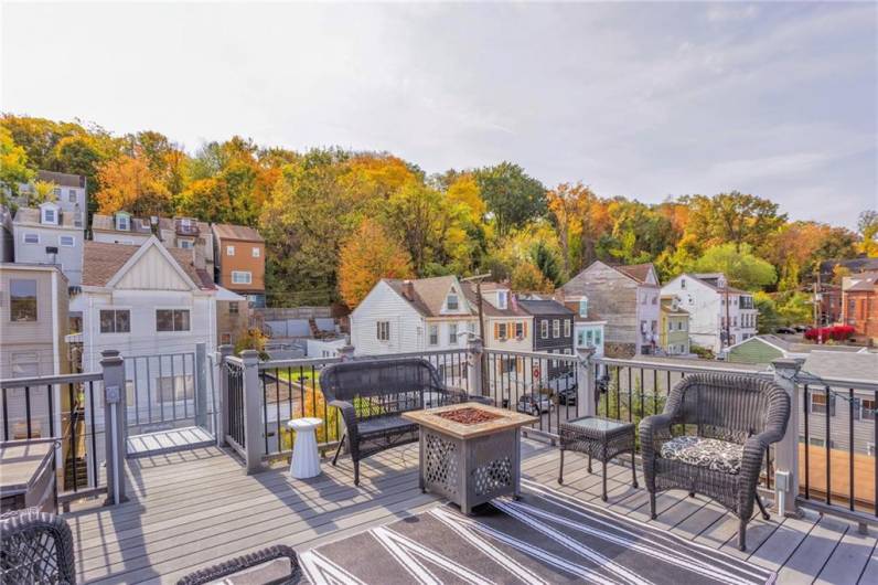 Rooftop deck with spiral staircase access. Equipped with outlets for media and lighting.