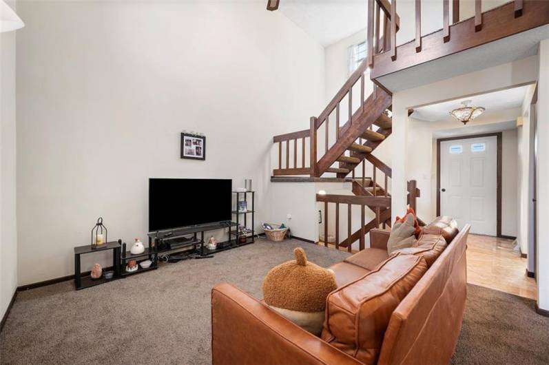 Living Room area and staircase to upstairs from Dining area