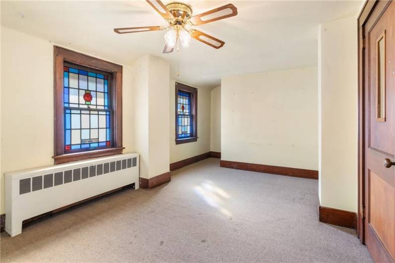 3rd room upstairs with ceiling fan & access door to attic.
