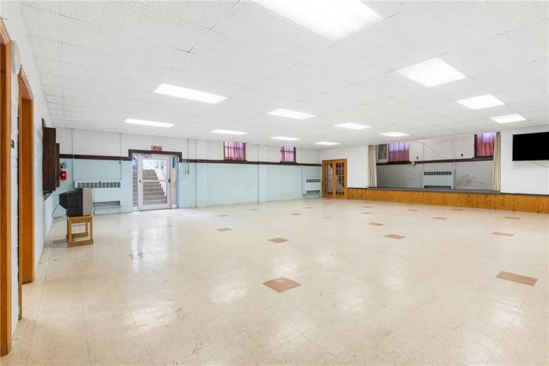 Large banquet area with stage & kitchen.