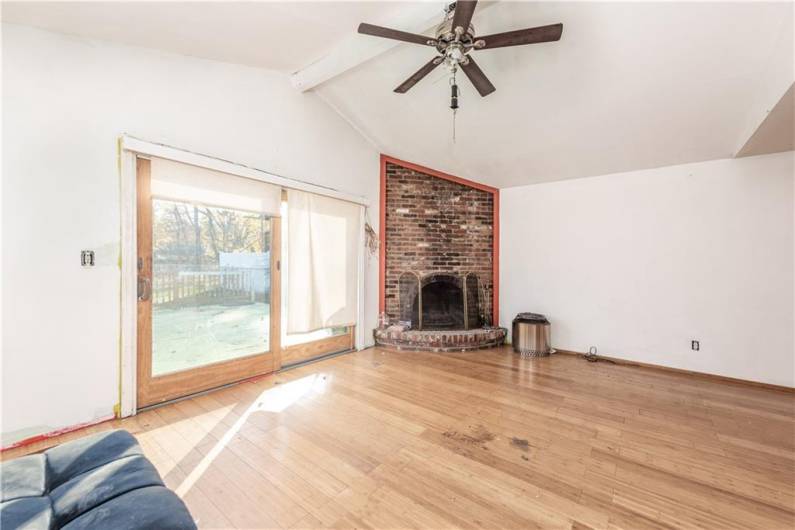 Vaulted ceilings ~ ceiling to floor log burning fire place that could be brought back to life with some HGTV hacks.