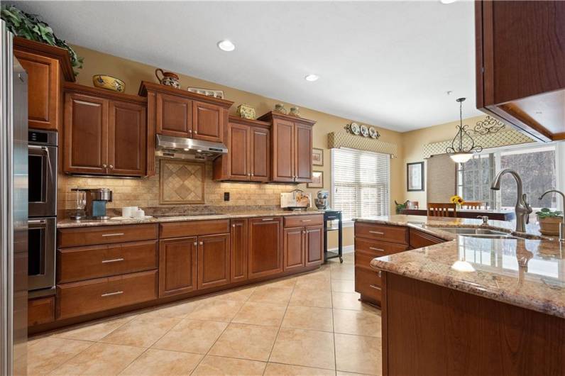 Elegant wooden cabinets complemented by exquisite granite countertops.