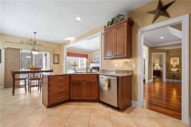 The open floor plan kitchen features elegant stainless steel appliances.