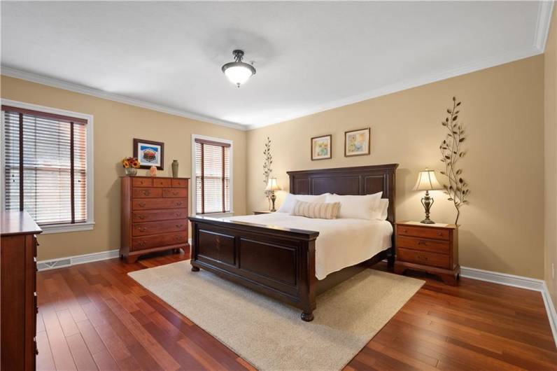 The primary bedroom features exquisite flooring and expansive open spaces.