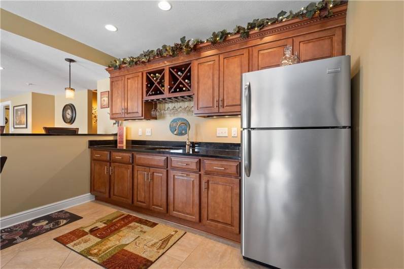 The basement nearly features a complete kitchen with wine storage and a refrigerator.