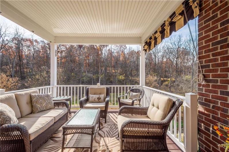 The second-floor covered porch offers stunning views.