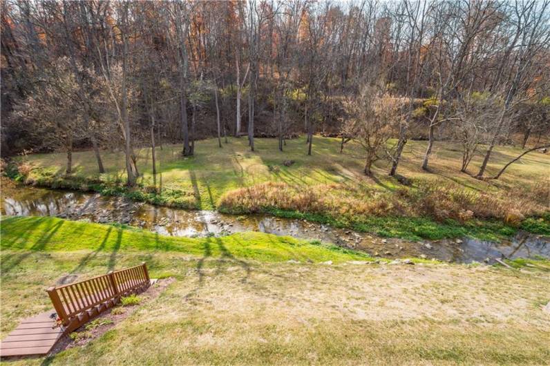 The property offers a stunning view of the Montour Trail and the creek, complete with a private set of stairs for easy access to enjoy the scenery.