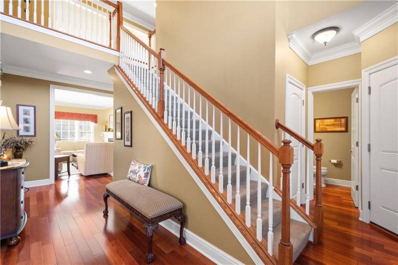 A stunning wooden staircase ascends to the second floor.