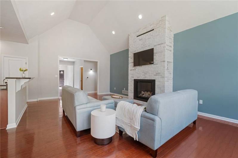 Living Room with Radiant-Heat Gas Fireplace and Hallway view to Front Door