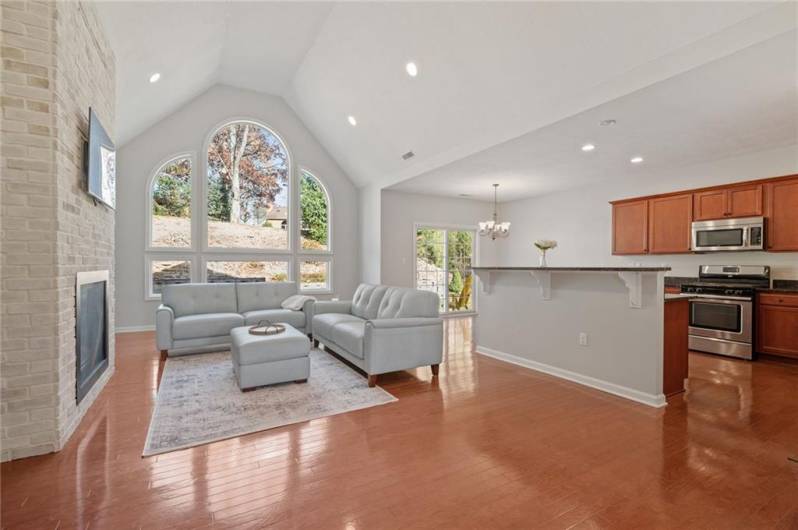 Living Room with Hardwood Floors.  Kitchen with Stainless Steel Appliances. Dining area with Slider to Back Patio.