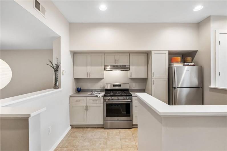 This open plan kitchen also features brand new appliances, and has plenty of floating countertops for easy entertaining and meal prep.