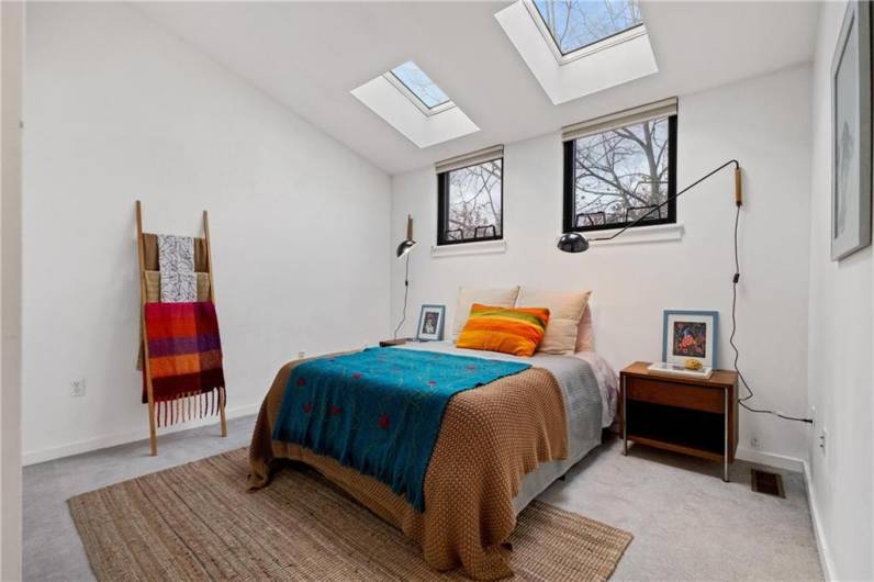 The primary is bathed in light with 2 large skylights and a spacious double closet.