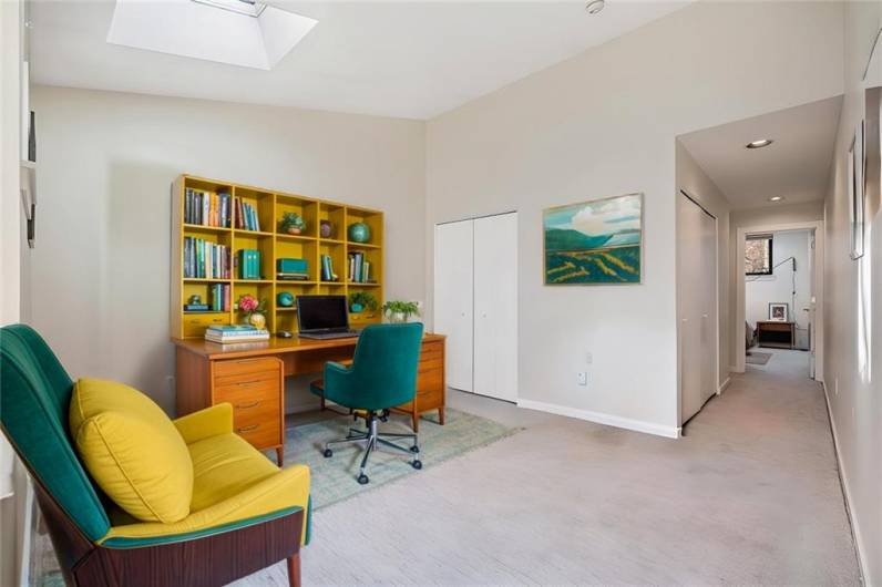 Virtually staged home office with additional seating area