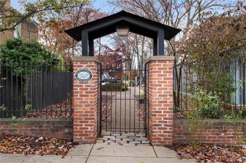 One of several lovely, gated entrances to this sought-after community in the heart of the South Side