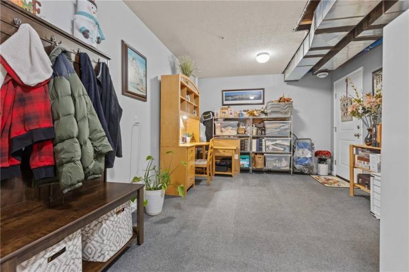 Cozy finished basement leading to the outback patio and porch swing.