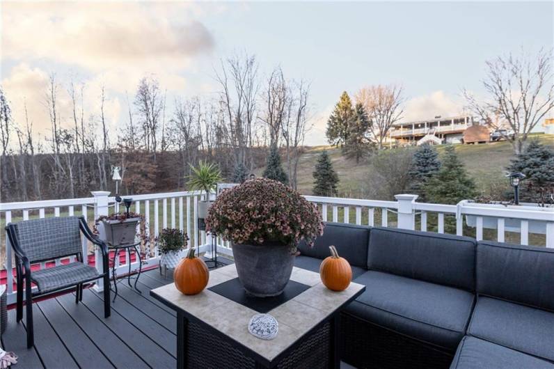 Enjoy a cup of coffee on this scenic back deck off of the kitchen and dining area.