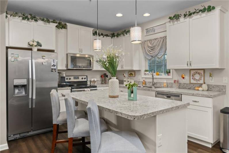 Open Concept kitchen with island open to the dining area, dining room area, and living/family room space.