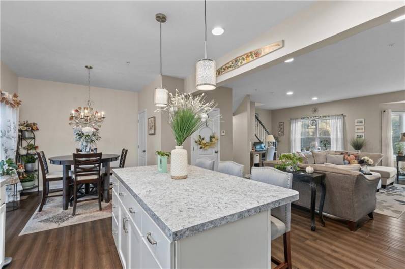 Open Concept kitchen with island open to the dining area, dining room area, and living/family room space.