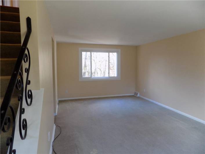 Spacious living room overlooks the backyard/