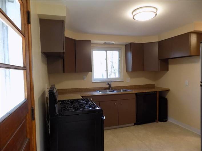 Kitchen door leads to side stairs and driveway.