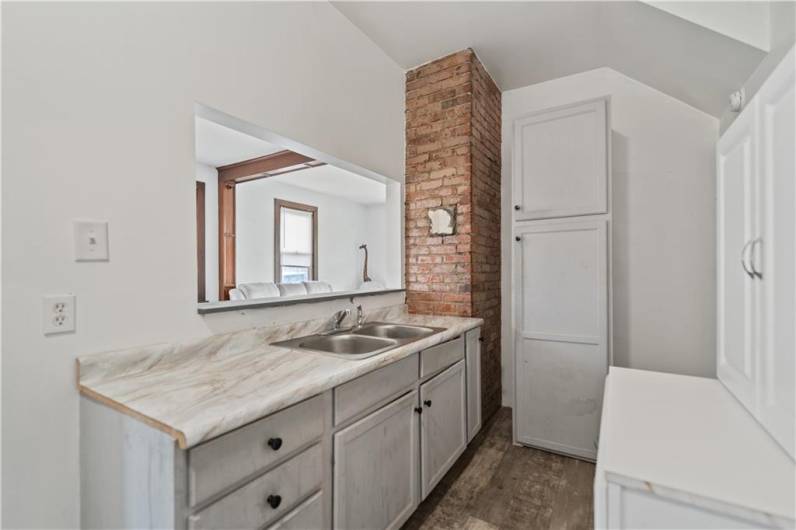 The kitchen has cool exposed brick accents...