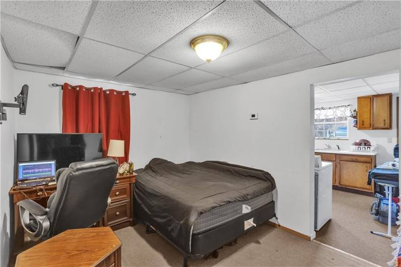 Apartment #2, living room, currently set up as bedroom. Open to kitchen and entry.