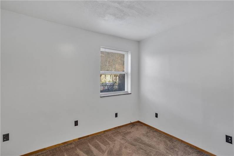 Bedroom in Apartment 1 with neutral carpet and fresh paint. Projected rent $500 used for the GAI calculation, but could likely get even more being a ground level apartment with adjacent parking.