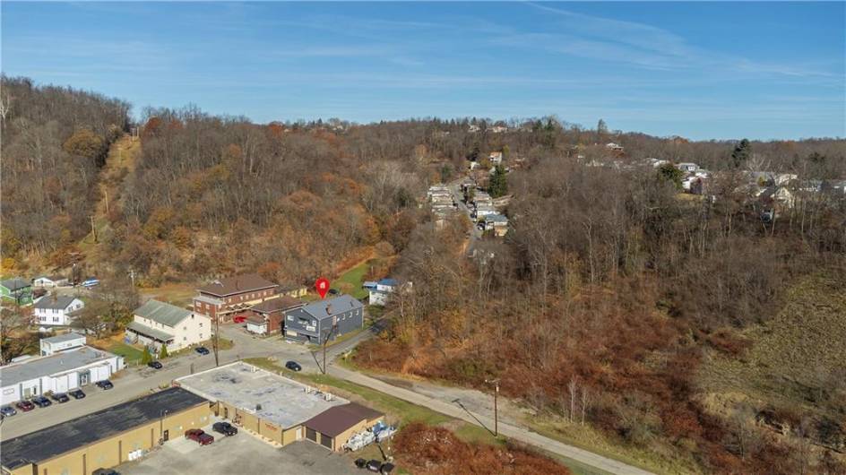 Partially Cleared 1.5 Acre Lot at Corner of Hill St. and Broadway with Woods at the Back for Extra Parking.