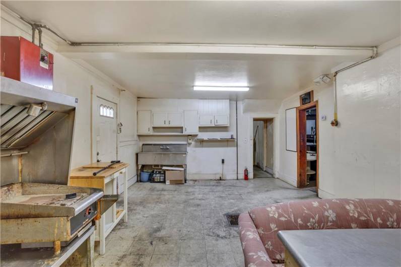 Another view of the Kitchen with 3 Bay Stainless Sink / Cabinets and Grill Area to left.