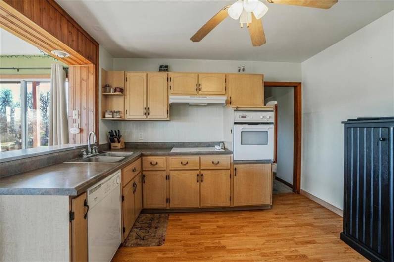 Well-appointed kitchen with plenty of counter space, classic cabinetry, and ceiling fan, making it a comfortable space for cooking and entertaining.