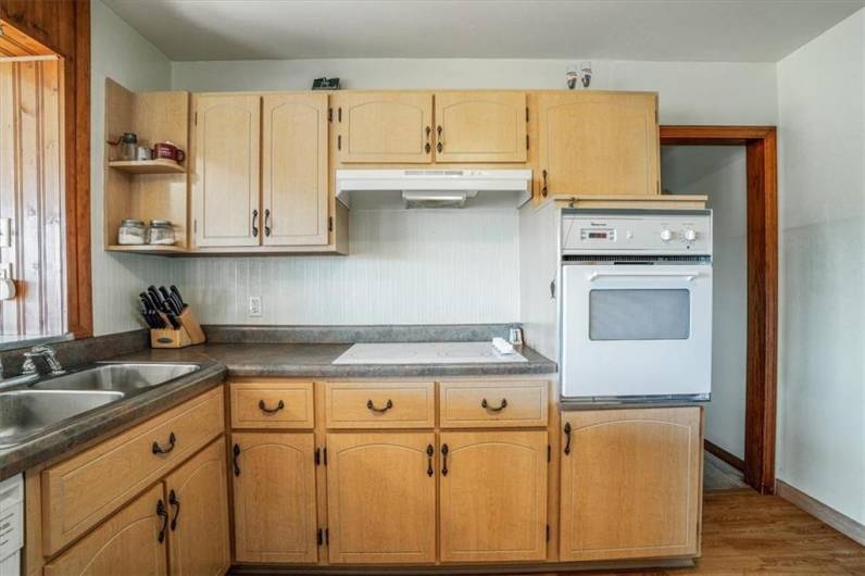 Well-equipped kitchen featuring ample storage space, classic cabinetry, and a built-in oven, providing functionality and convenience for home cooking.