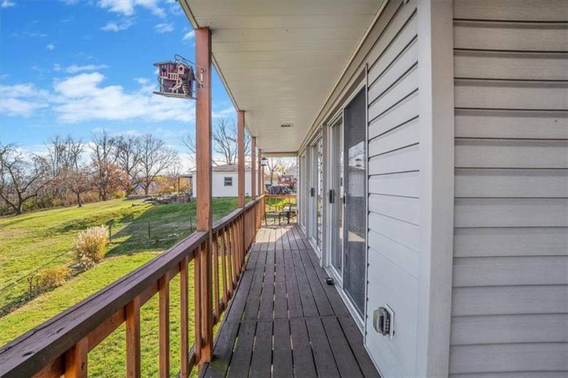 This elevated deck offers a peaceful retreat, overlooking a spacious yard and beautiful natural surroundings. Perfect for outdoor dining or simply enjoying the view.