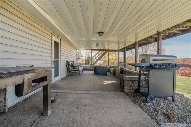 A covered outdoor space with plenty of room for grilling and seating, making it ideal for summer barbecues and gatherings with friends and family.