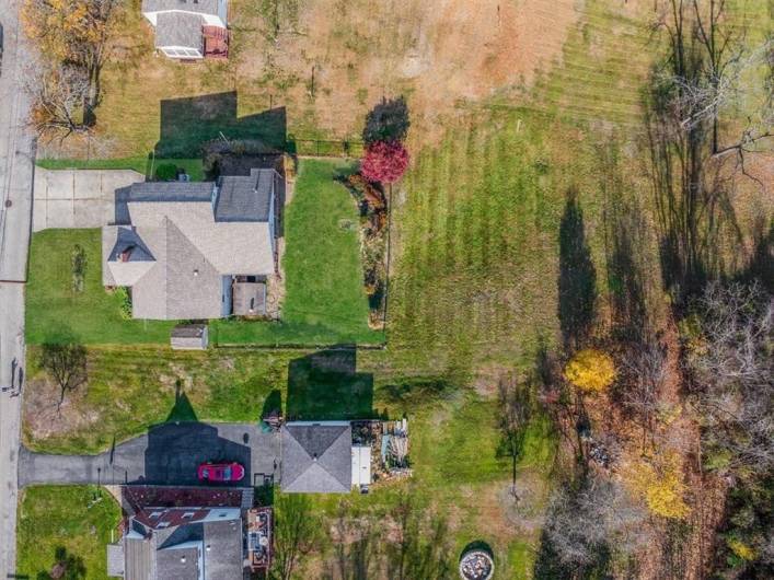 Overhead perspective of the backyard, showcasing an expansive green space perfect for outdoor activities and relaxation in a peaceful setting.