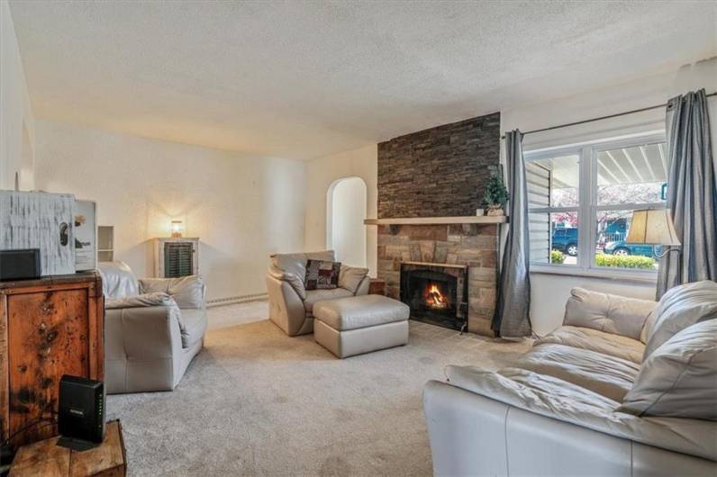 Cozy living room as seen from the stairwell, offering a comfortable seating area and easy flow to other parts of the home, ideal for relaxing or entertaining.