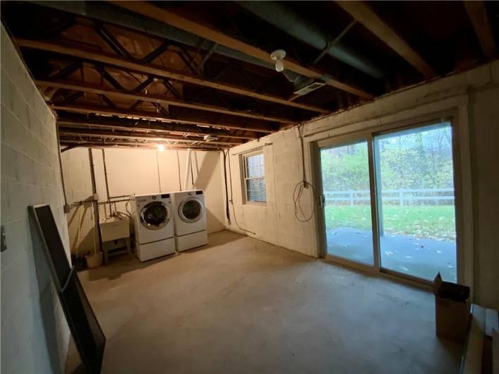 Basement/Laundry area with a sliding glass door out to a patio