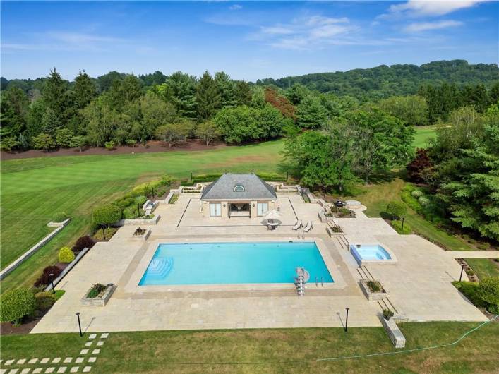 30x60 ft saltwater pool with hot tub. Custom stone pool house.