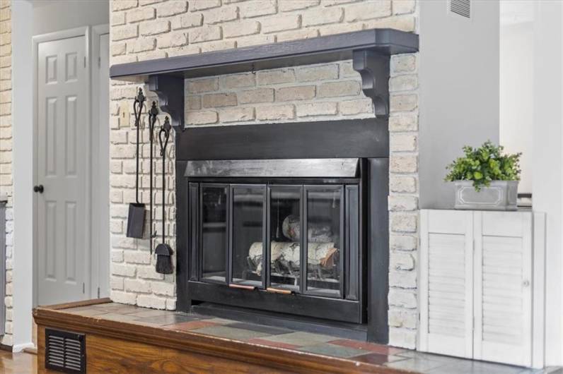 Fireplace adds charm to eat in kitchen.